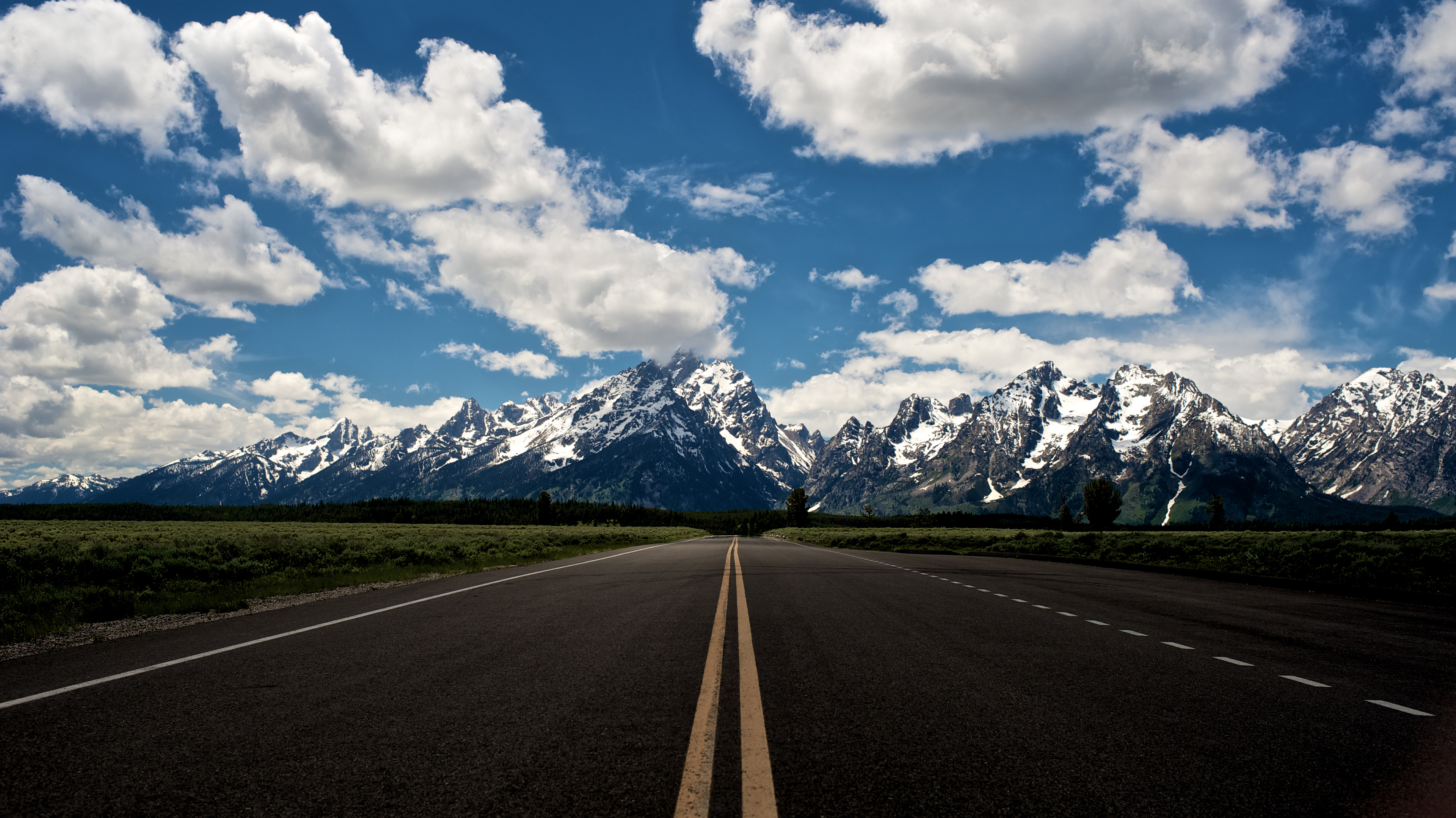 Empty Lanes, Highway, Rocky Mountains With Snow, Blue Sky And White