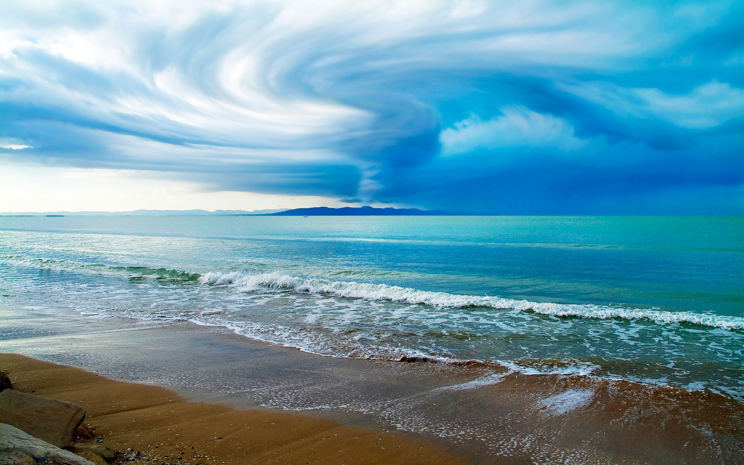 Swirling Clouds Above The Ocean Beach Wallpaper 2560x1600