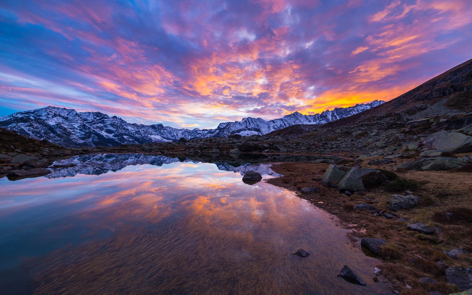 Alpine Lake In Italian Alps Colorful Sky Sunset Snow Mountain Range